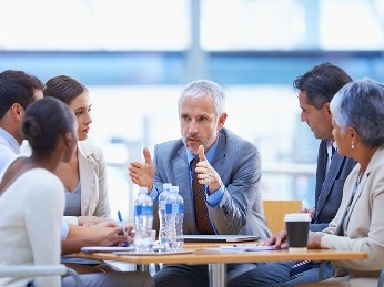 A man talking to a group of people.