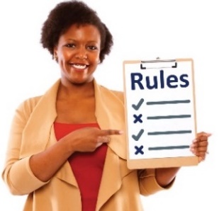 A smiling woman pointing to a clipboard with with a rules list on it.