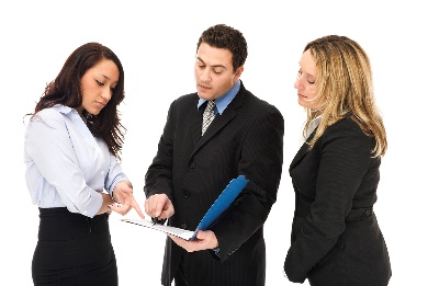 A group of people looking at a document together.