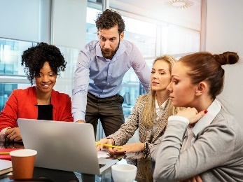 A group of people looking at a document together.