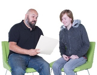 A man and young woman looking at a document together.