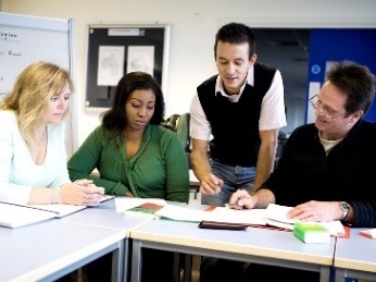 A group of people reading a document together. 